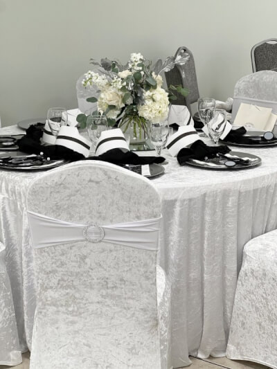 Monochromatic Elegance with White Velvet Tablecloth, Chair Covers, Styled Napkins & Lush Florals