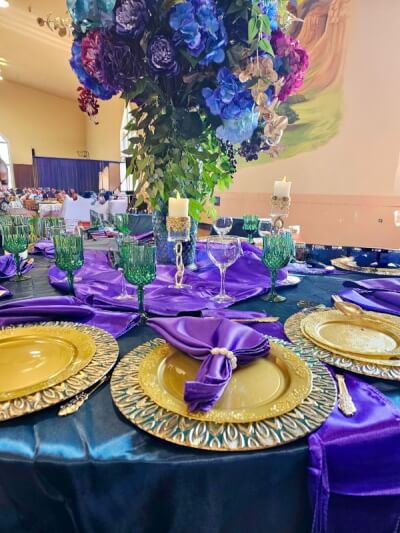 Regal Jewel-Tone Table Setting with Satin Napkins, Ornate Chargers & Vibrant Floral Centerpiece