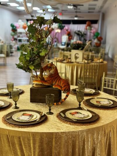 Wild Jungle Theme Party Featuring Gold Velvet Linens, Rustic Chargers & Safari-Inspired Centerpiece